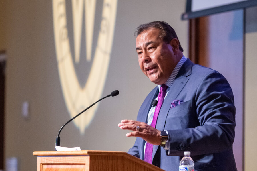 John Quinones speaking at the podium